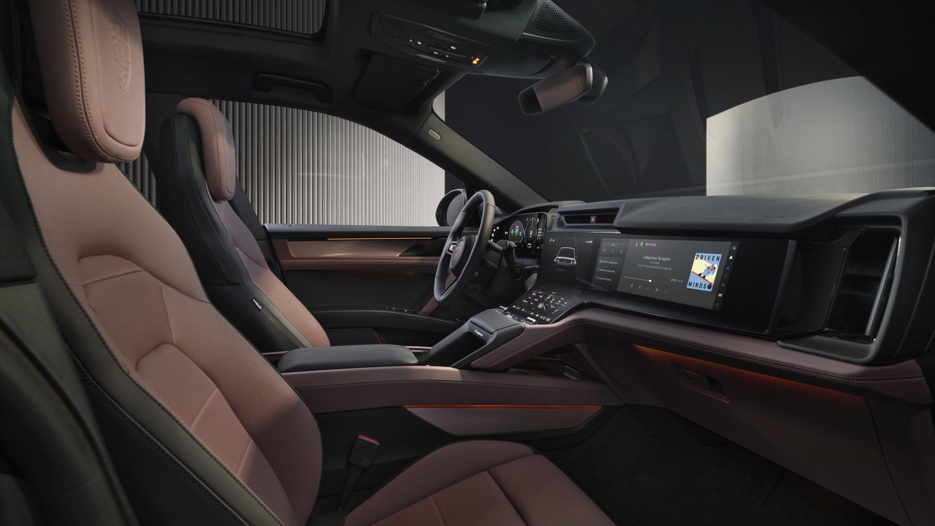 Passenger-side interior of the 2026 Porsche Cayenne Turbo Electric with premium seating and a wide digital infotainment display.
